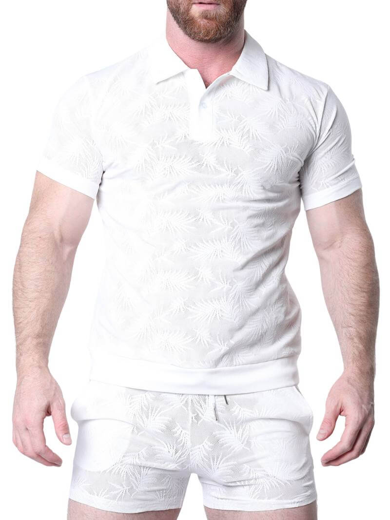 Man wearing a white patterned shirt against a perforated metal background
