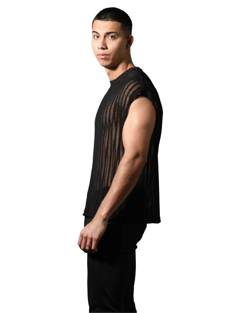 Man wearing a black sleeveless top with sheer mesh panels on a white background