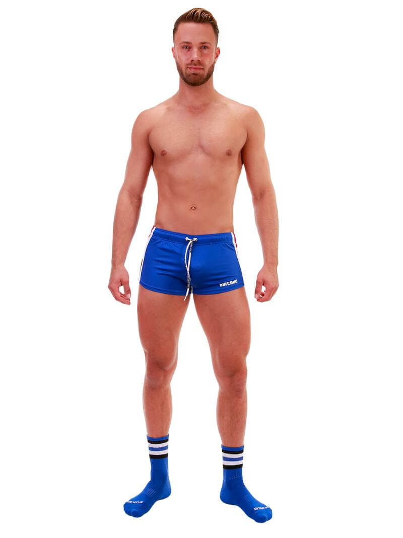 A model wearing royal blue short-legged shorts with sporty side stripes and a drawstring waist.