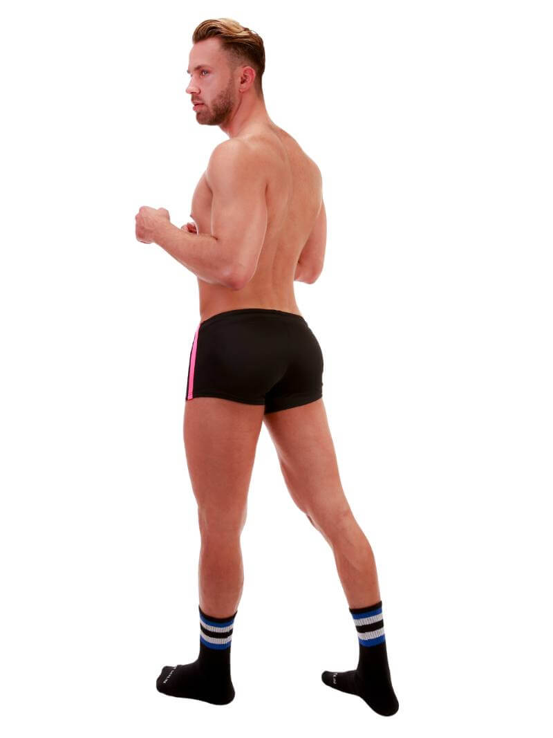 A model wearing royal blue short-legged shorts with sporty side stripes and a drawstring waist.