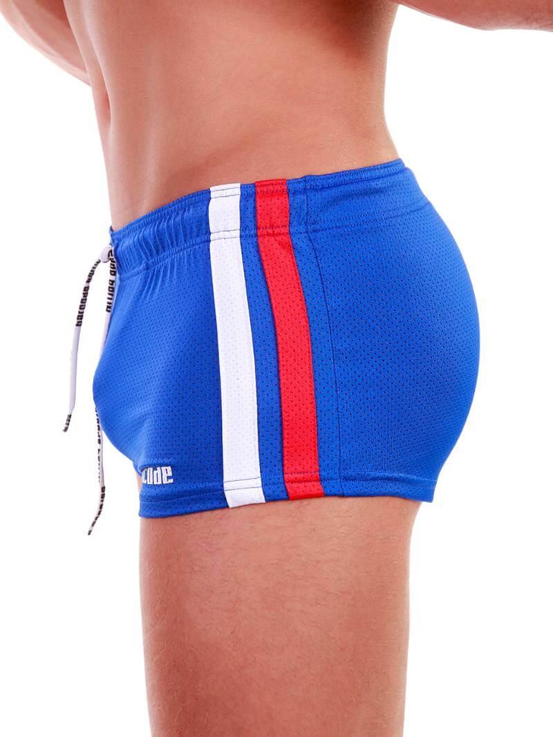 A model wearing royal blue short-legged shorts with sporty side stripes and a drawstring waist.