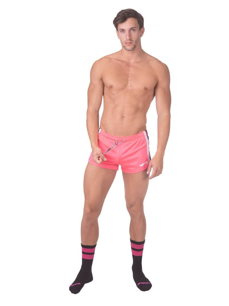 A model wearing royal blue short-legged shorts with sporty side stripes and a drawstring waist.