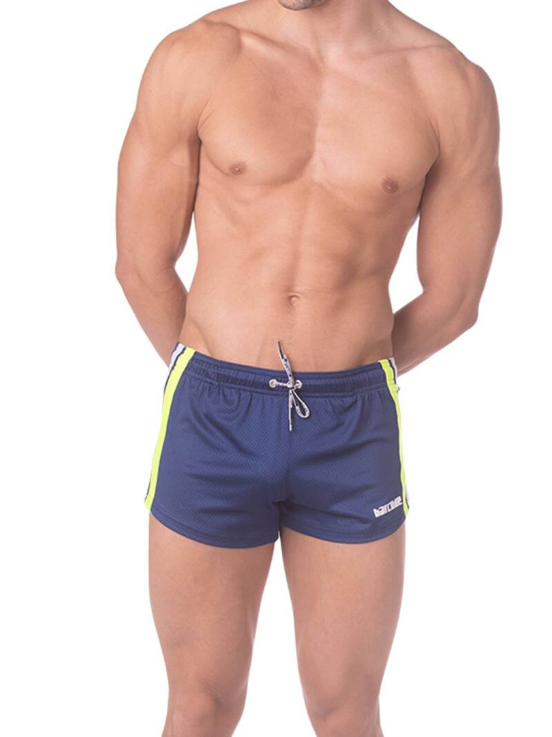 A model wearing royal blue short-legged shorts with sporty side stripes and a drawstring waist.