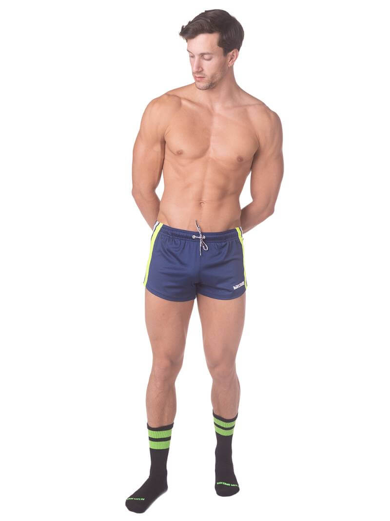 A model wearing royal blue short-legged shorts with sporty side stripes and a drawstring waist.