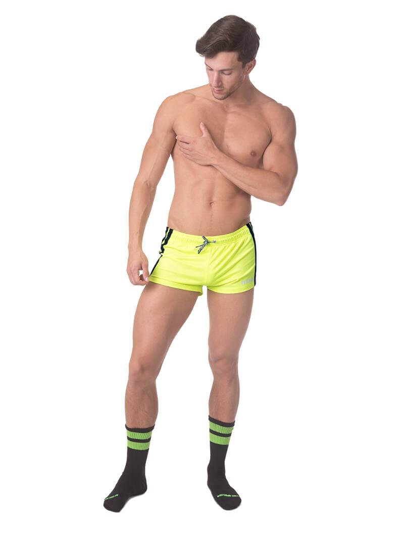 A model wearing royal blue short-legged shorts with sporty side stripes and a drawstring waist.