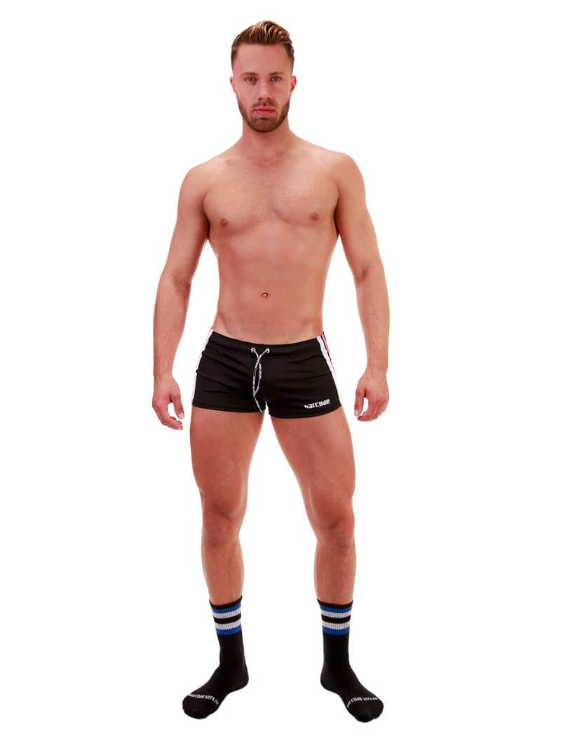 A model wearing royal blue short-legged shorts with sporty side stripes and a drawstring waist.