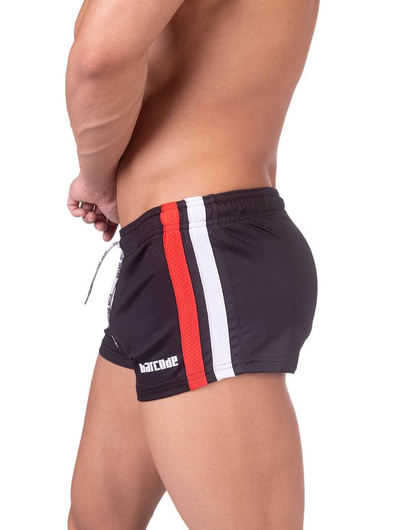A model wearing black short-legged shorts with sporty side stripes and a drawstring waist.