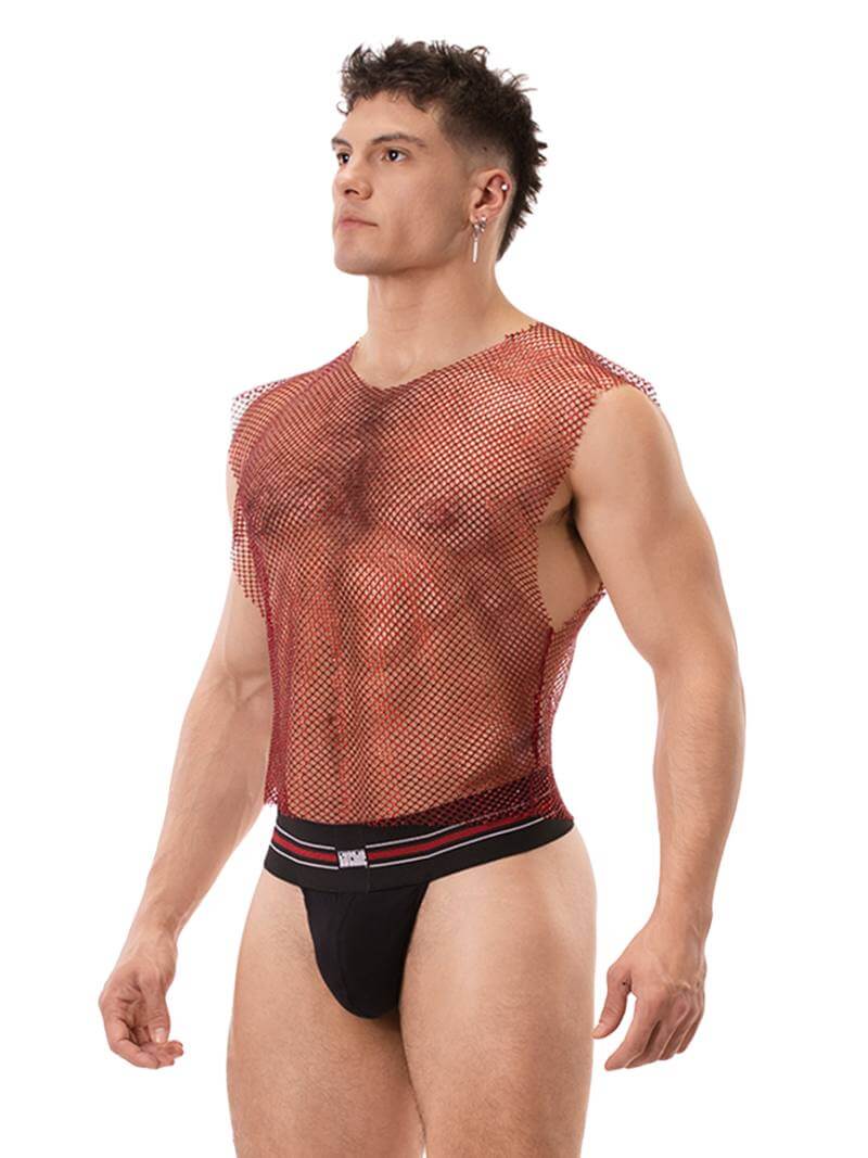 A male model wearing a sleeveless, round neck, mesh tank top in red with glitter accents, paired with black shorts with red trim. The tank top has a clubwear and partywear style, semi-see-through with a shimmering effect.