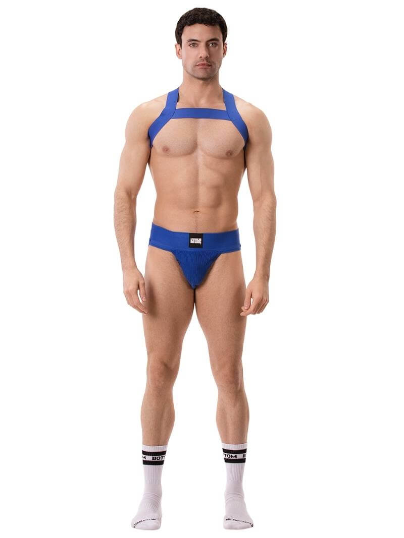 A man wearing a blue elastic chest harness with straps across the chest and over the shoulders.