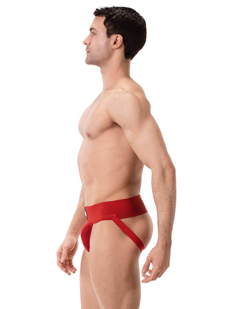 A model wearing a white Barcode Berlin Sergey ribbed cotton jockstrap, with the brand label visible on the waistband.