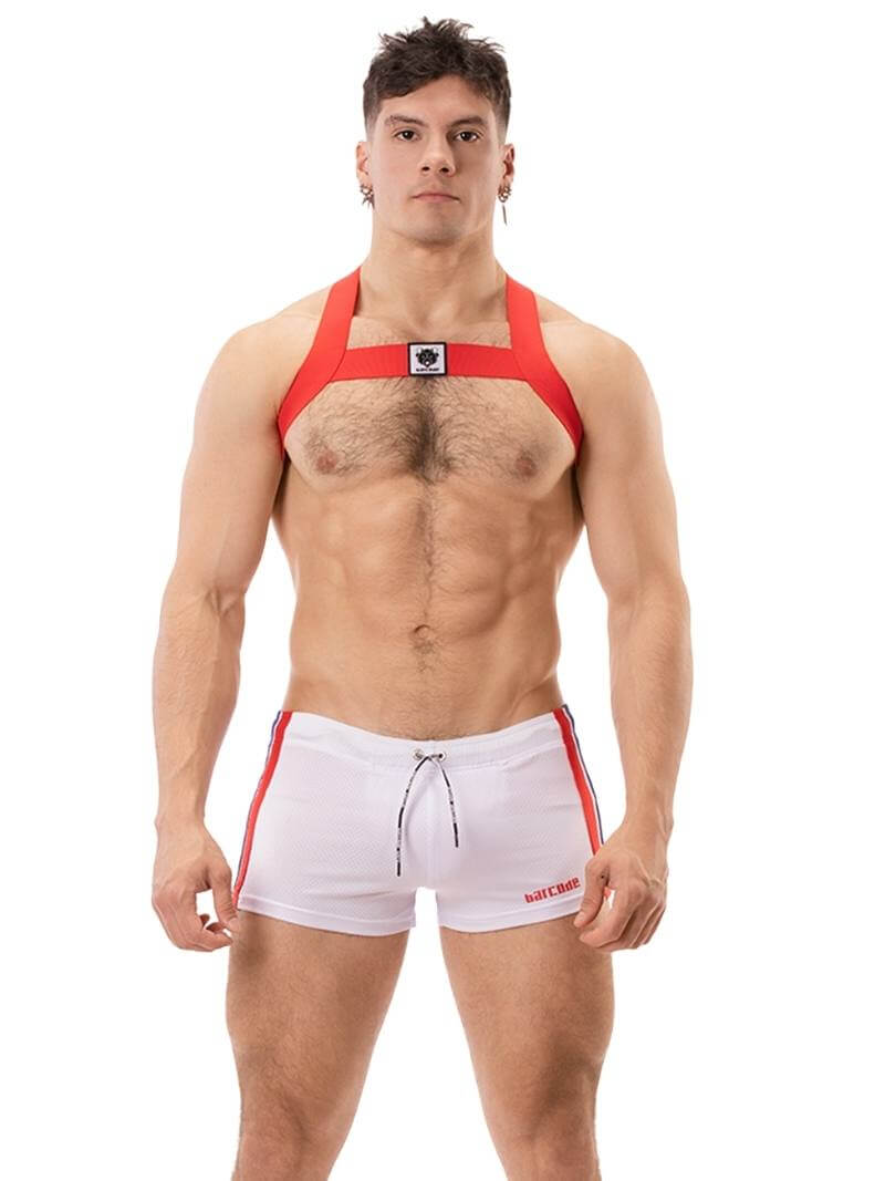 A model wearing black short-legged shorts with sporty side stripes and a drawstring waist.