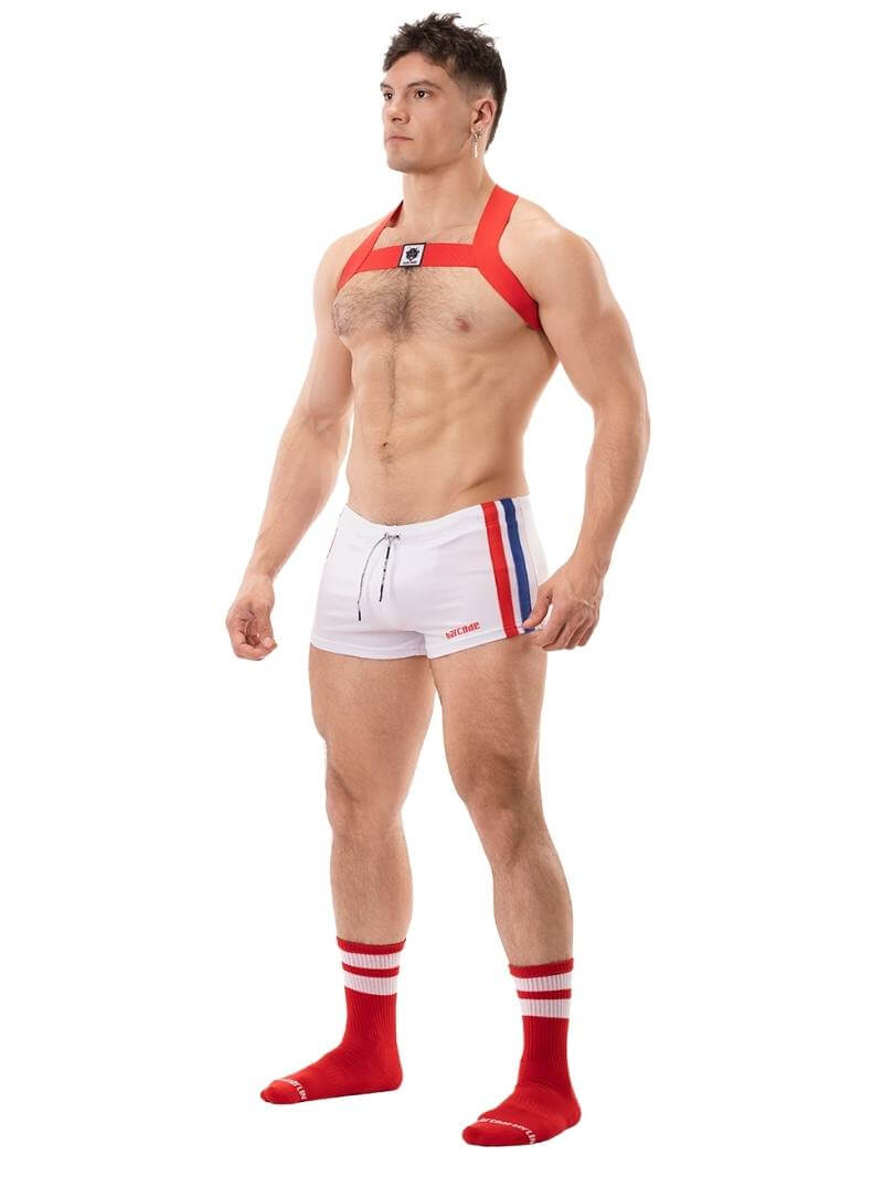 A model wearing black short-legged shorts with sporty side stripes and a drawstring waist.