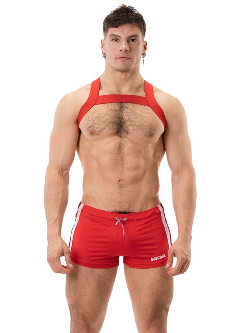 A model wearing black short-legged shorts with sporty side stripes and a drawstring waist.