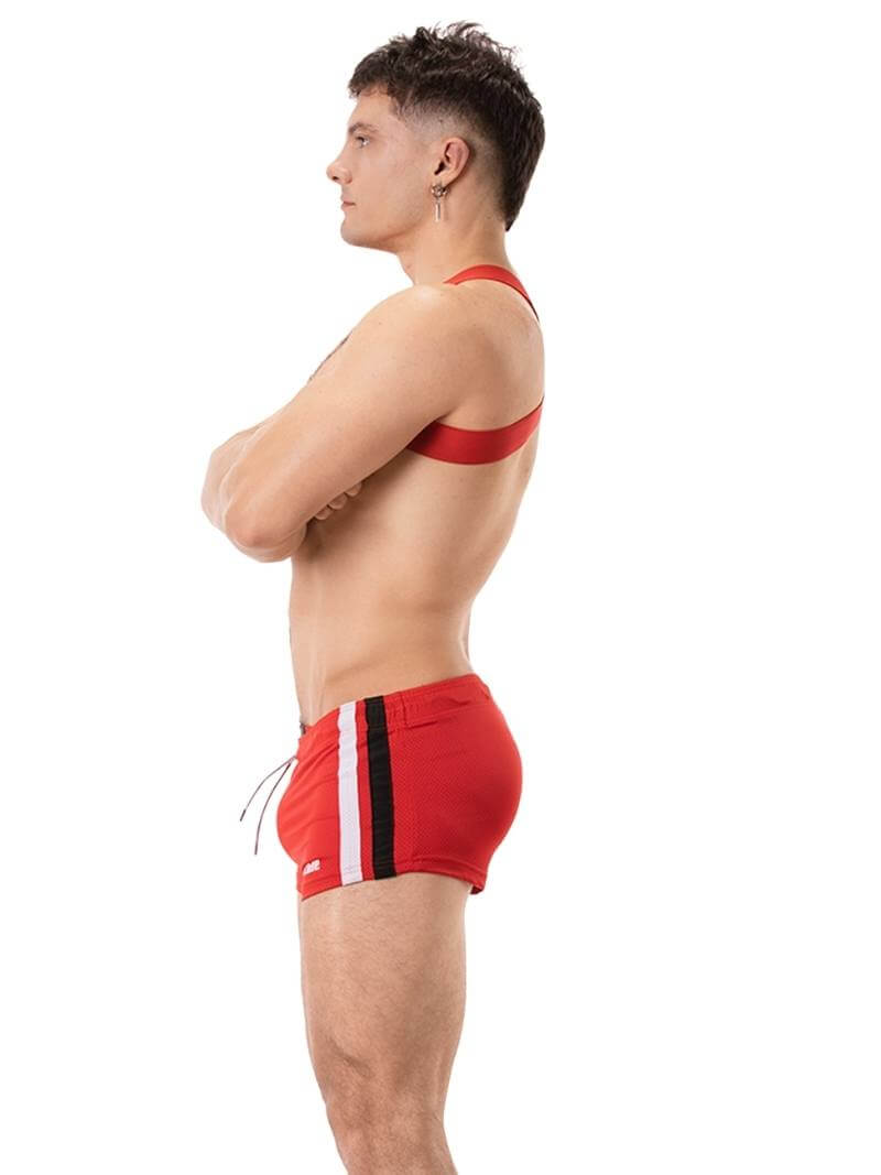 A model wearing black short-legged shorts with sporty side stripes and a drawstring waist.