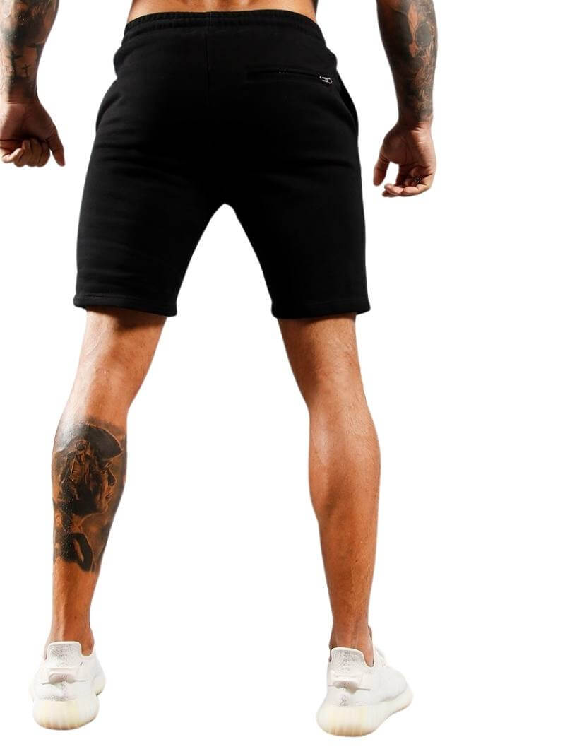 Person wearing black shorts on a white background