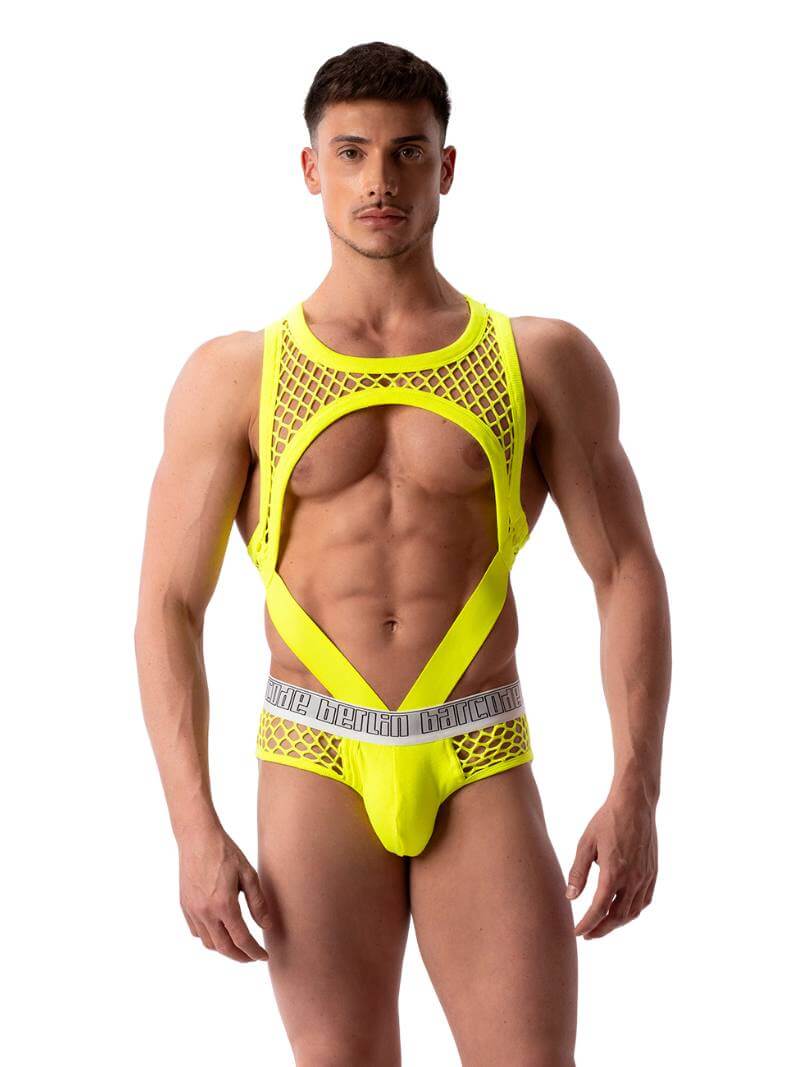 A male model wearing a black mesh partywear gay tank harness with a fishnet design.