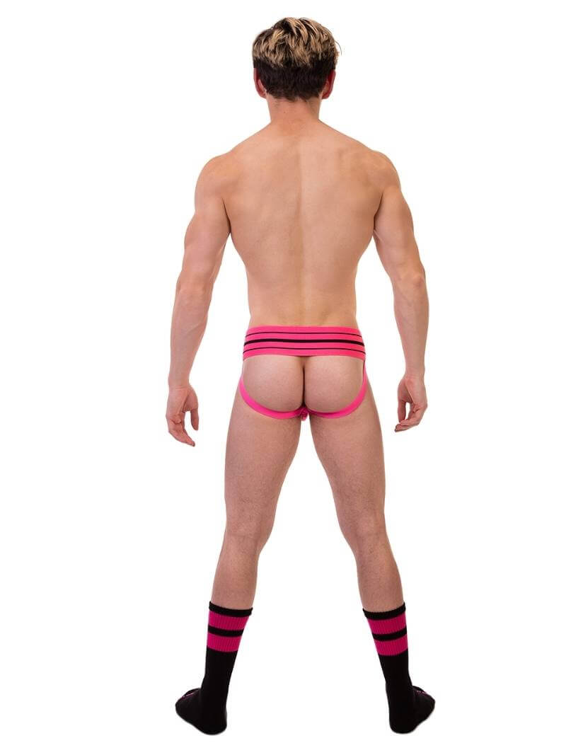 A model wearing a pink BARCODE Berlin Andreus jockstrap, with the brand label visible on the striped waistband, showcasing the product's design and fit.