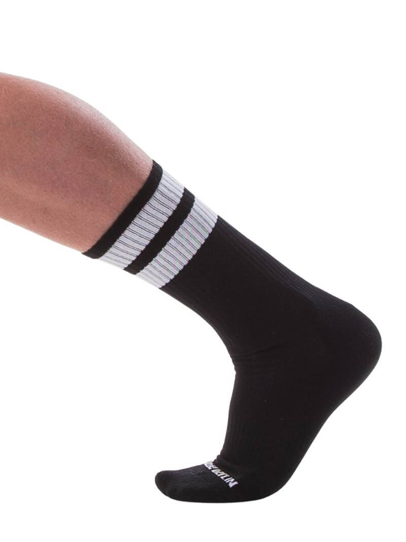 A pair of black gym crew socks with pink stripes, featuring the Barcode Berlin brand logo on the ankle area.