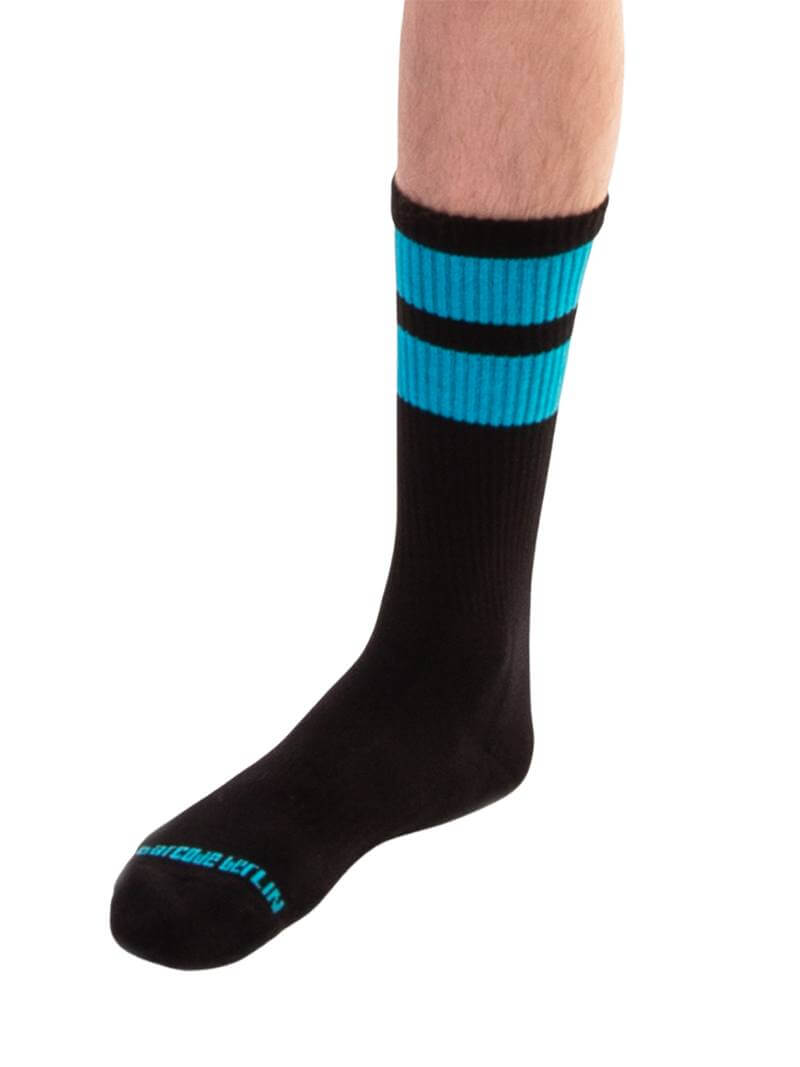 A pair of black gym crew socks with pink stripes, featuring the Barcode Berlin brand logo on the ankle area.