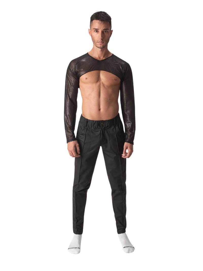 A male model wearing a black semi-see-through sheer mesh crop top with long sleeves and a v-neck.