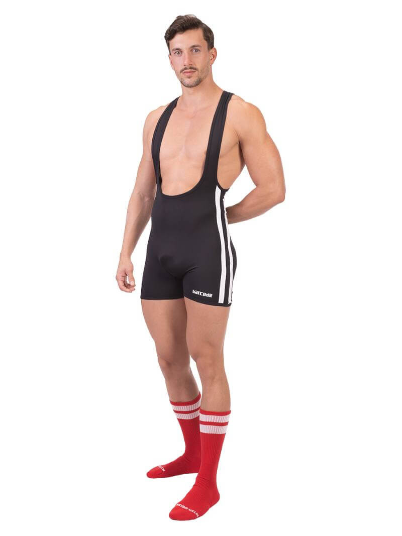 A man wearing a black Barcode Berlin backless singlet with white stripes and a low-cut neck.