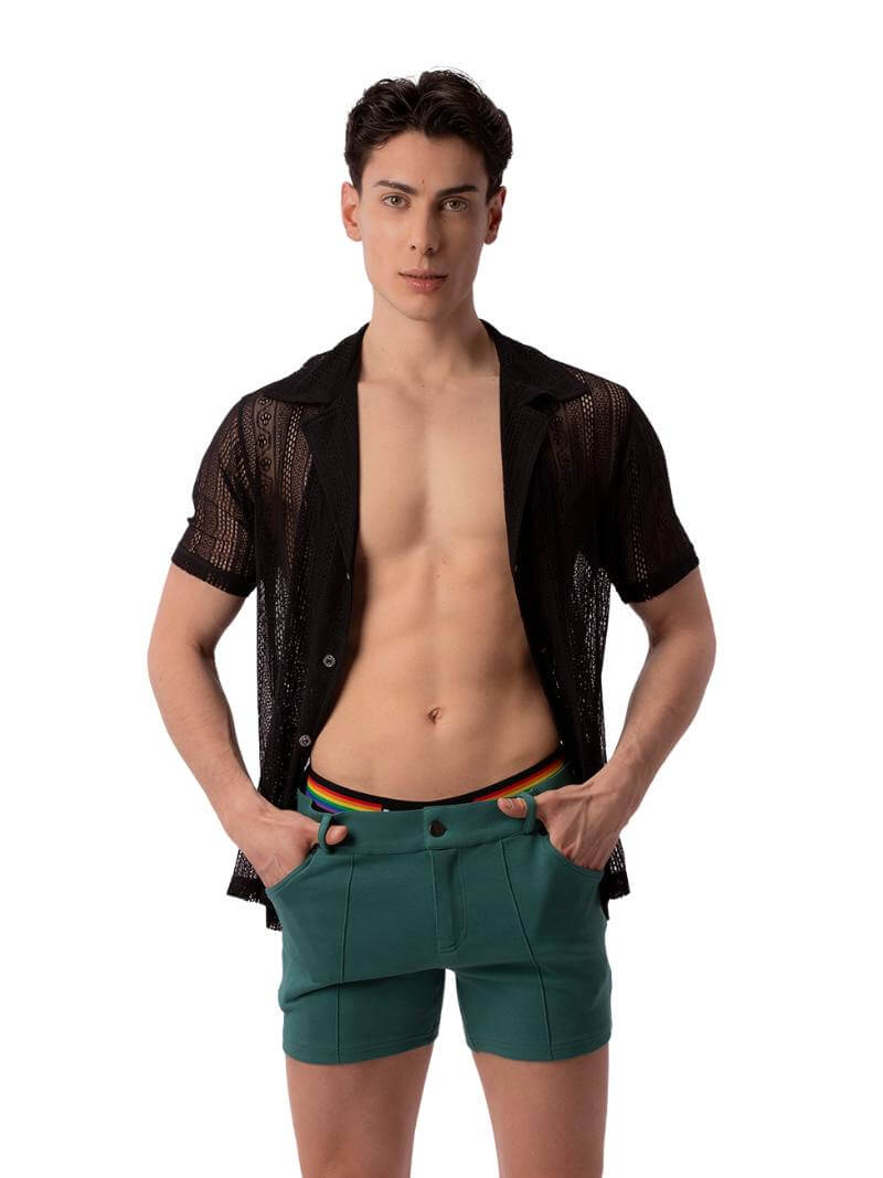 A male model wearing a black, semi-see-through lace shirt with short sleeves and a collared neck.