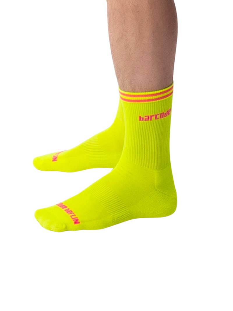 A pair of bright neon yellow Barcode Berlin Festival socks with red and yellow stripes and the brand name 'BARCODE' written in red on the ankle area.