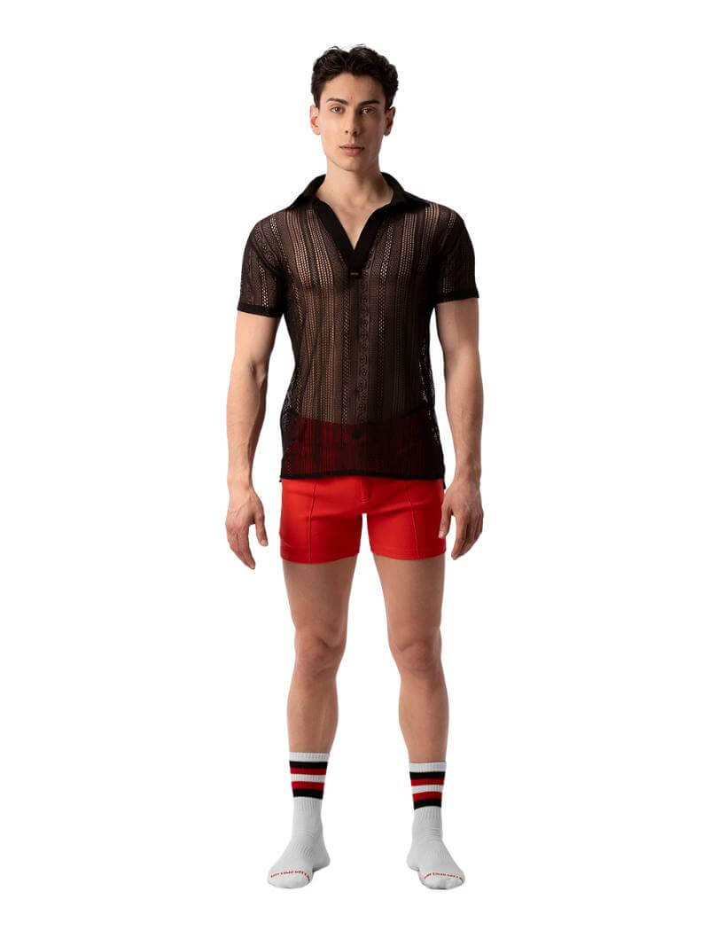 A model wearing a semi-see-through black lace polo shirt with a collard v-neck and short sleeves.