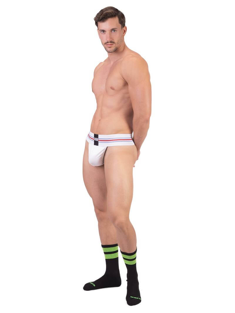 A model wearing a white Barcode Berlin thong, with the brand label visible on the waistband.