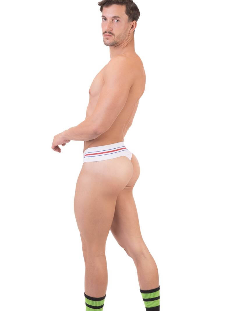 A model wearing a white Barcode Berlin thong, with the brand label visible on the waistband.