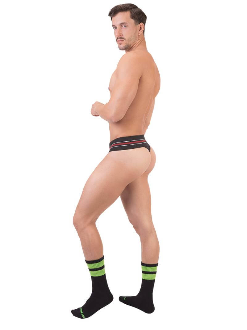 A model wearing a white Barcode Berlin thong, with the brand label visible on the waistband.