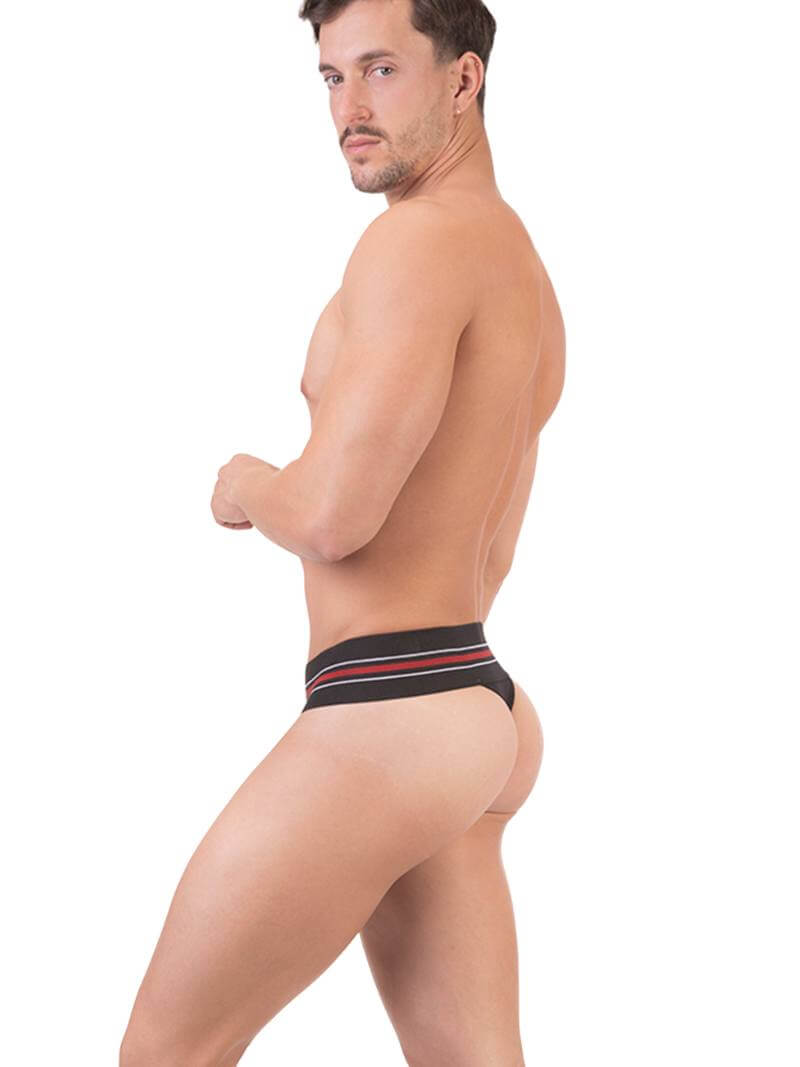 A model wearing a white Barcode Berlin thong, with the brand label visible on the waistband.