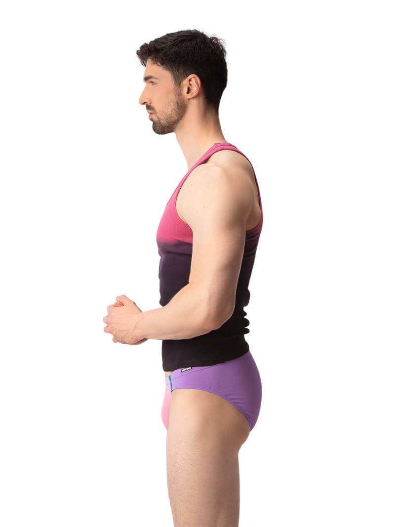 A male model wearing a sleeveless black tank top with a gradient of blue to pink and the text 'F**KING HOT' in the center, along with a 'BARCODE' branded label at the back.
