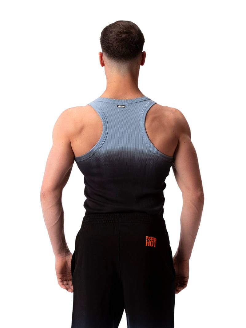 A male model wearing a sleeveless black tank top with a gradient of blue to pink and the text 'F**KING HOT' in the center, along with a 'BARCODE' branded label at the back.