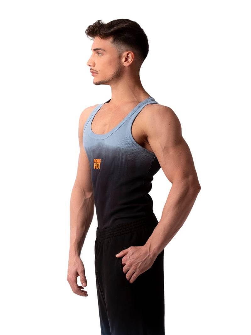 A male model wearing a sleeveless black tank top with a gradient of blue to pink and the text 'F**KING HOT' in the center, along with a 'BARCODE' branded label at the back.