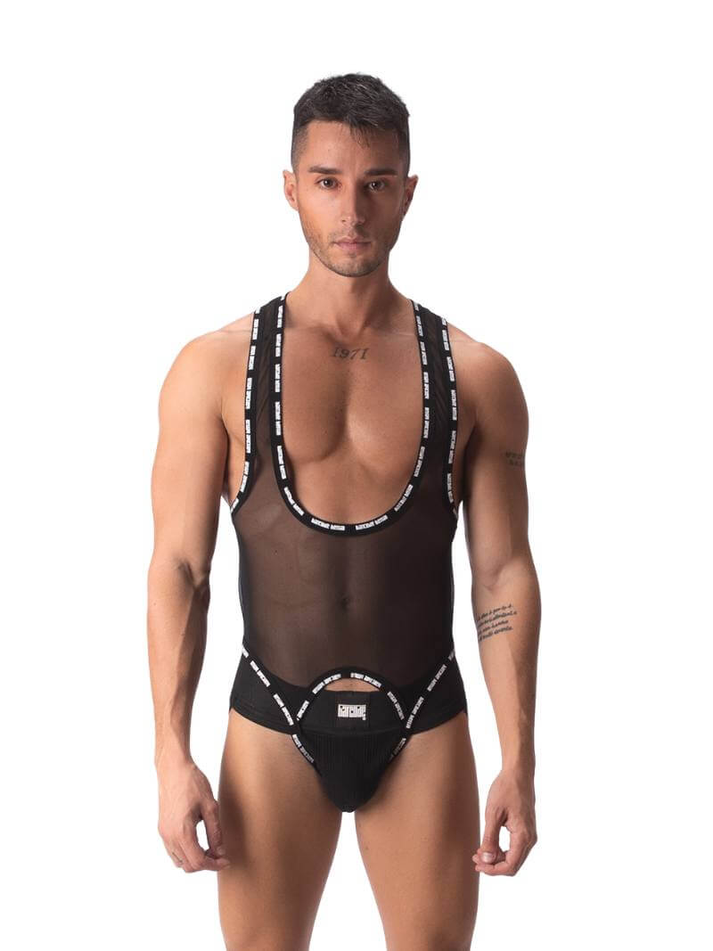 A male model wearing a black sheer mesh Barcode Berlin singlet with branded trims, featuring a crotchless front and a jockstrap rear.