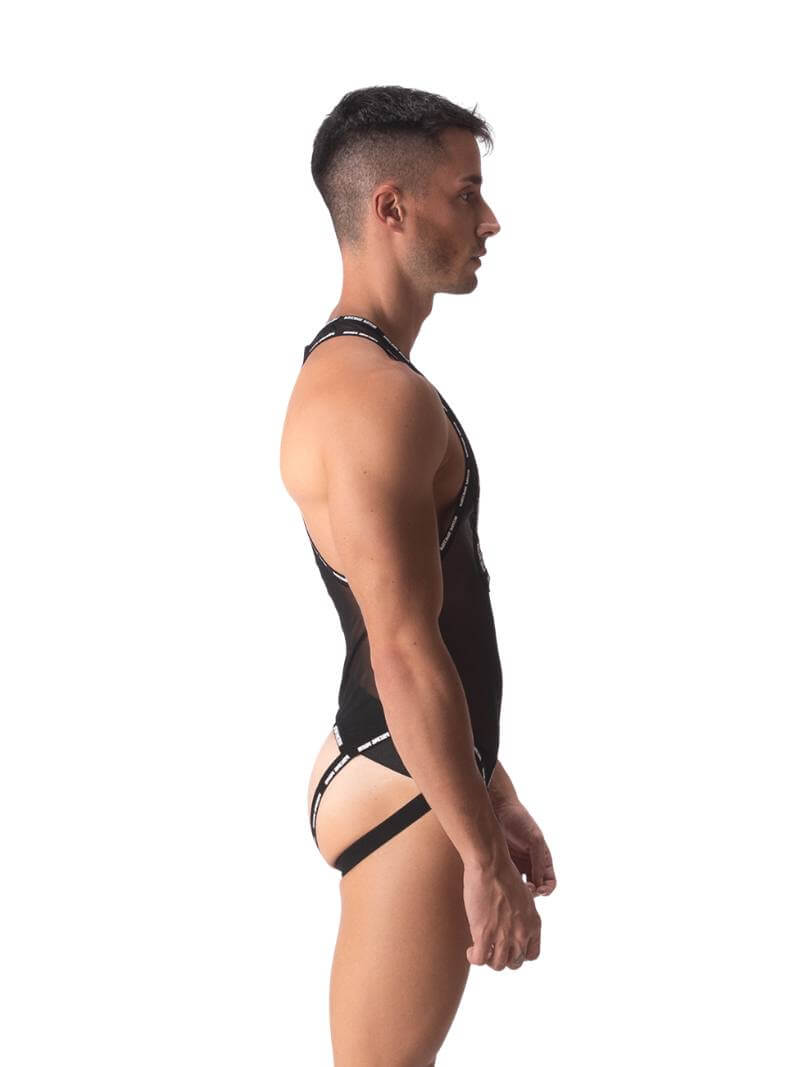 A male model wearing a black sheer mesh Barcode Berlin singlet with branded trims, featuring a crotchless front and a jockstrap rear.