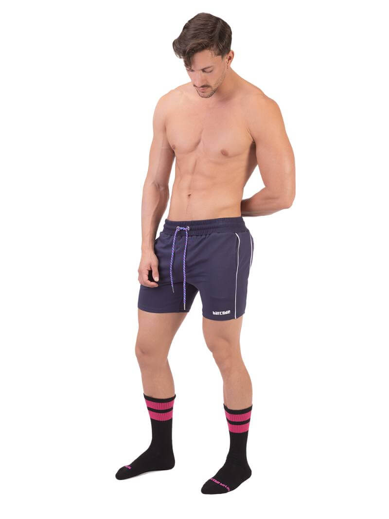 A model wearing red Barcode Berlin Lukio Casual Mid Thigh shorts with drawstring