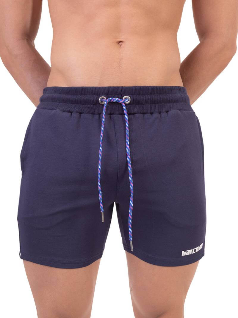 A model wearing red Barcode Berlin Lukio Casual Mid Thigh shorts with drawstring