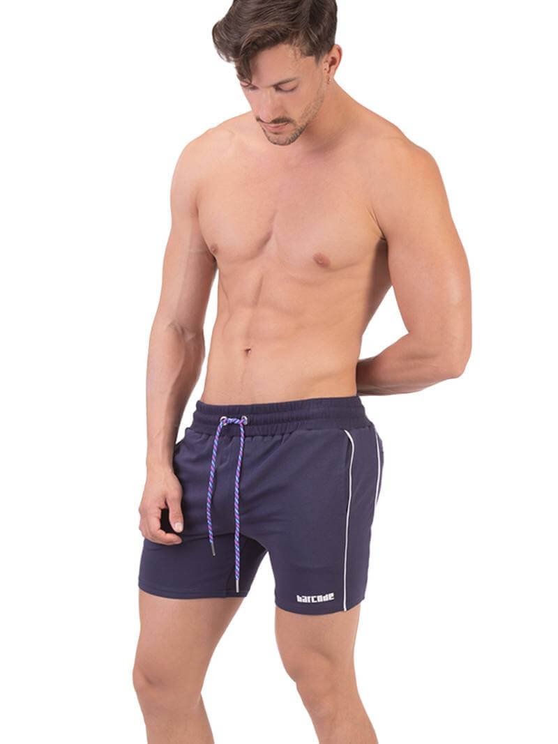 A person wearing black Barcode Berlin Lukio shorts with white trim stripes and a patterned drawstring.