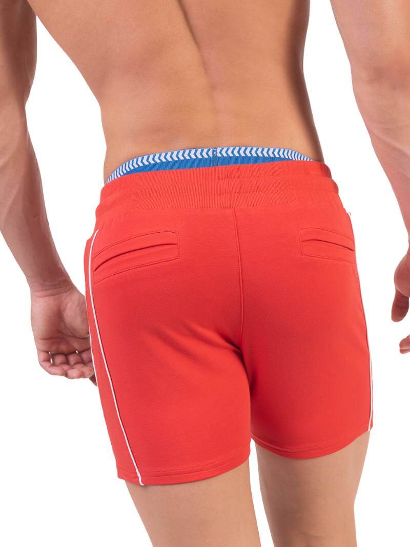 A model wearing red Barcode Berlin Lukio Casual Mid Thigh shorts with drawstring