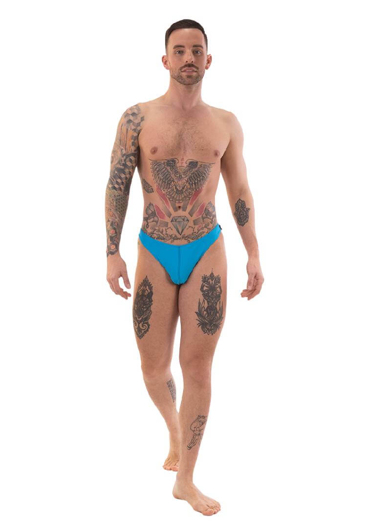 A person wearing red micro swimwear with a geometric pattern and the Barcode Berlin brand logo on the waistband.