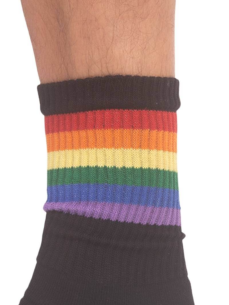 A pair of mid-calf black gym socks with colorful pride stripes on the cuff, featuring the Barcode Berlin brand logo.