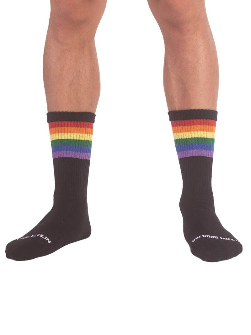 A pair of mid-calf black gym socks with colorful pride stripes on the cuff, featuring the Barcode Berlin brand logo.