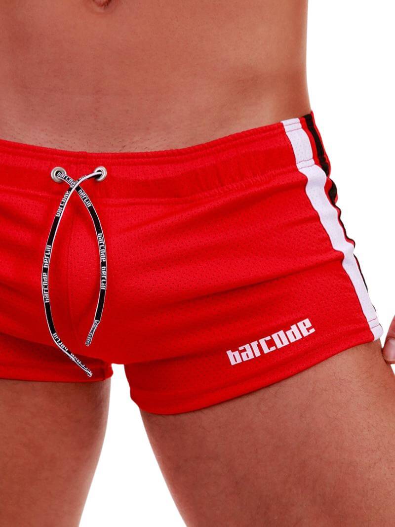 A model wearing black short-legged shorts with sporty side stripes and a drawstring waist.