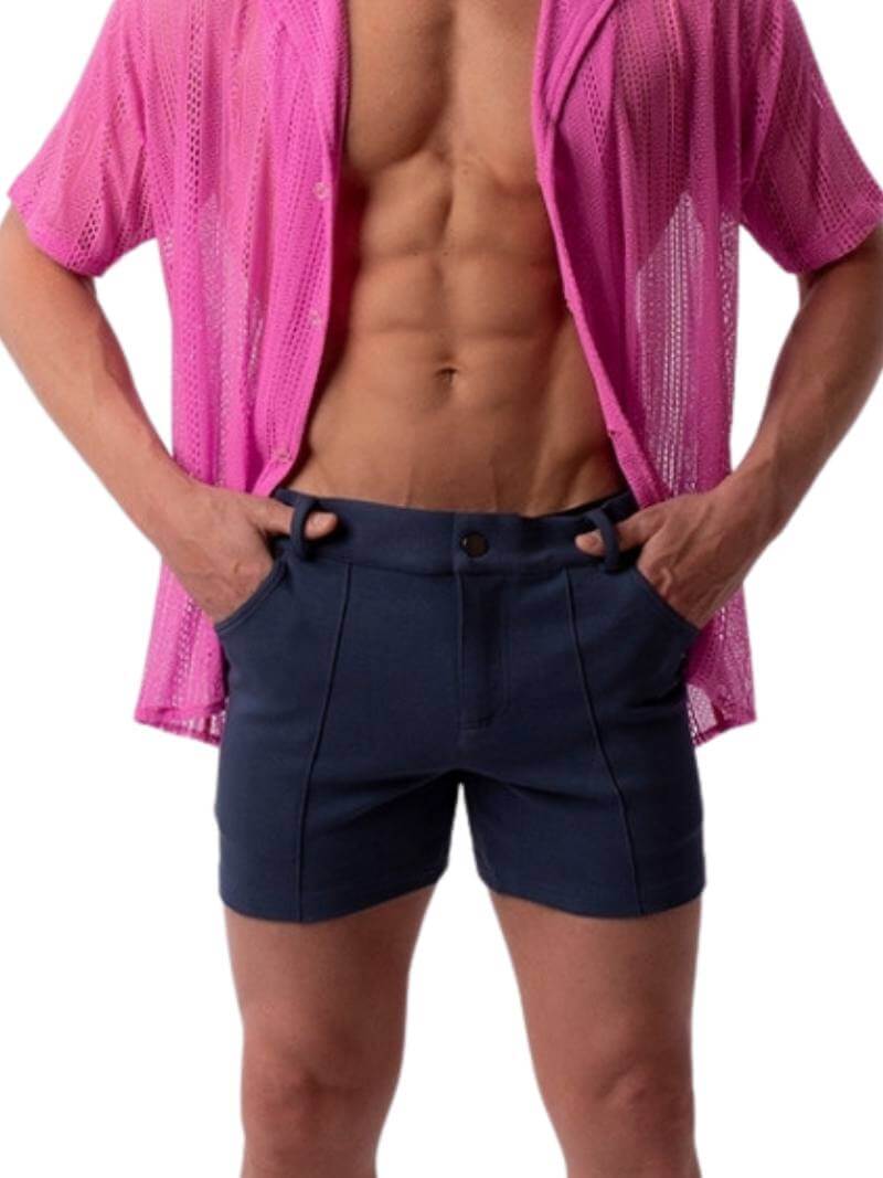 A pair of navy blue, short-leg Barcode Berlin Simon shorts with a pink, short-sleeve shirt in the background.