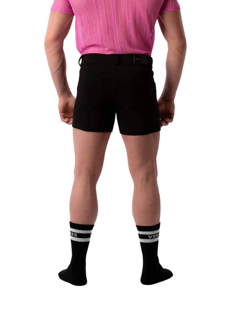 A pair of navy blue, short-leg Barcode Berlin Simon shorts with a pink, short-sleeve shirt in the background.