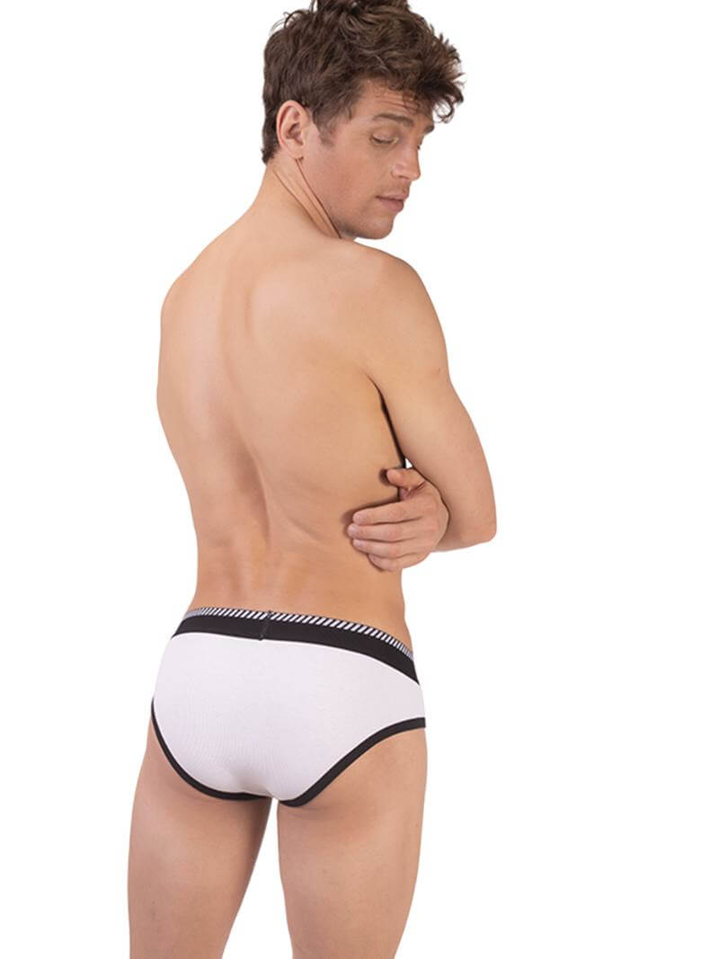 A man wearing a white Barcode Berlin brief with black trims and a brand logo on the waistband.