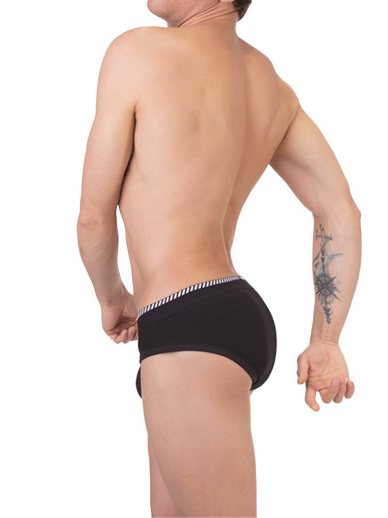 A man wearing a white Barcode Berlin brief with black trims and a brand logo on the waistband.
