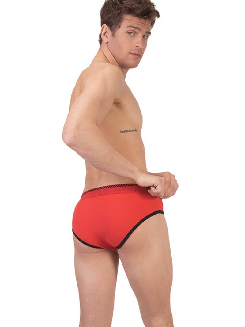 A man wearing a blue Barcode Berlin brief with white trims and a brand logo on the waistband.